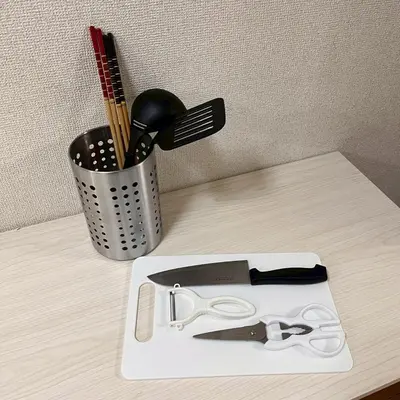 a white cutting board with a pair of scissors on a counter at \u6953 -Kaede- in Tokyo