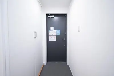 a hallway with a black door in a room at monthly PRIME asakusa in Tokyo