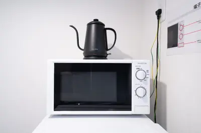 a microwave with a tea kettle on top of it at monthly PRIME asakusa in Tokyo