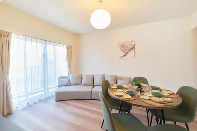 a living room with a table and a couch at monthly AQUA RESIDENCE Sangenjaya in Tokyo