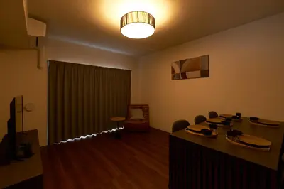 a meeting room with a table and chairs and a light at monthly AQUA RESIDENCE Sangenjaya in Tokyo