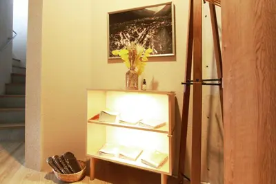 a book shelf with books and a vase of flowers at \u62b9\u8336\u5eb5\u4e09\u8336\u6771\u4eac Matcha-An Sancha Tokyo #202 in Tokyo