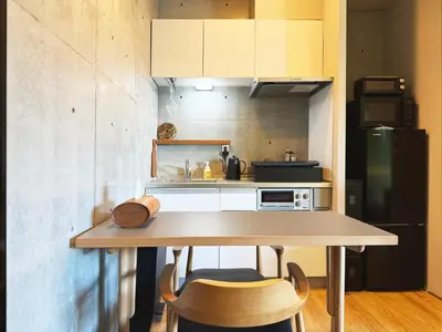 a small kitchen with a table with two chairs at \u62b9\u8336\u5eb5\u4e09\u8336\u6771\u4eac Matcha-An Sancha Tokyo #202 in Tokyo