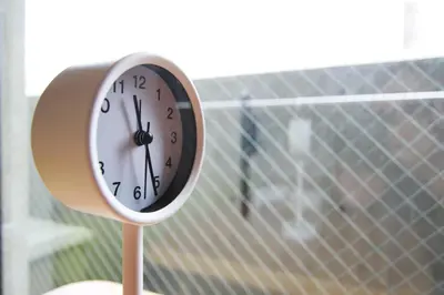 a clock sitting on a stand in front of a window at \u62b9\u8336\u5eb5\u4e09\u8336\u6771\u4eac Matcha-An Sancha Tokyo #202 in Tokyo