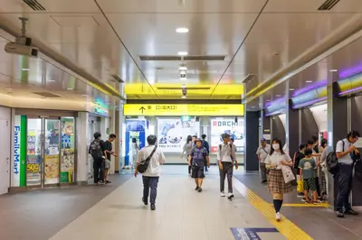 a group of people walking in a subway station at Cruise Inn Kitasenju Station Front1 in Tokyo