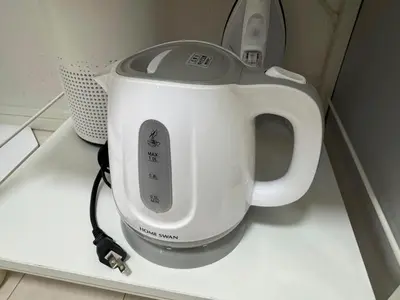 a white tea kettle sitting on top of a counter at Cruise Inn Kitasenju Station Front1 in Tokyo