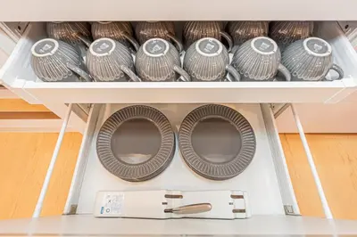 a drawer filled with plates and other dishes at 120sqm 5LDK 3-Stories House 3BT JR Shin-Okubo 5min in Tokyo