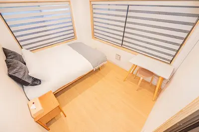 a small bedroom with a bed and a desk and a window at 120sqm 5LDK 3-Stories House 3BT JR Shin-Okubo 5min in Tokyo