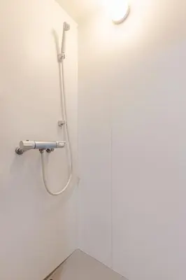 a shower in a bathroom with a white wall at Rtt\u5357\u5143\u753a12 in Tokyo