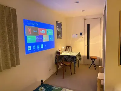 a room with a table and a sign on the wall at \u5730\u4e0b\u9244\u99c5\u5f92\u6b695\u5206 \u30c7\u30a3\u30ba\u30cb\u30fcDisney\u30d0\u30b9 \u7fbd\u7530\u7a7a\u6e2f \u30ea\u30e0\u30b8\u30f3\u30d0\u30b9 \u7bc9\u6d45 \u6c34\u5727\u826f JAPAN STAY Pearl in Tokyo
