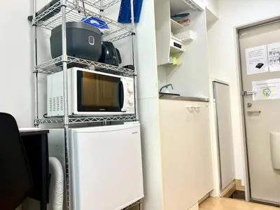 a kitchen with a refrigerator and a microwave at Gracious Higashishinjuku - Vacation STAY 35567v in Tokyo
