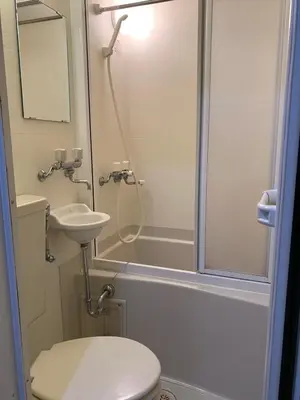 a bathroom with a shower and a toilet and a sink at Gracious Higashishinjuku - Vacation STAY 35567v in Tokyo