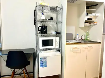 a small kitchen with a counter and a microwave at Gracious Higashishinjuku - Vacation STAY 35567v in Tokyo