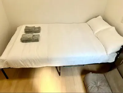 a bed with two pillows on it in a room at Gracious Higashishinjuku - Vacation STAY 35525v in Tokyo