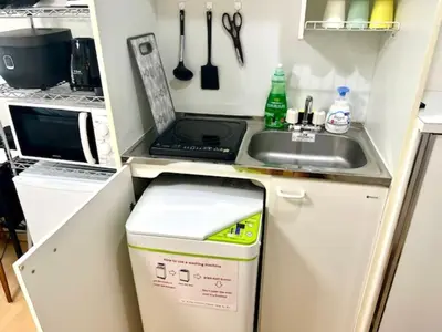 a small kitchen with a sink and a stove at Gracious Higashishinjuku - Vacation STAY 35525v in Tokyo