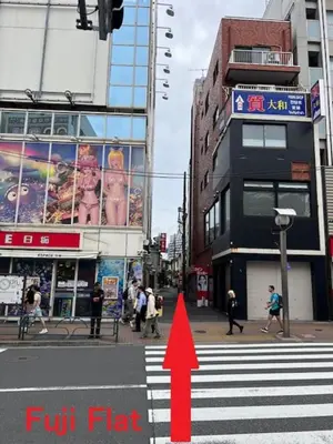 a red arrow pointing to a city street with people crossing the street at Fuji Flats - Vacation STAY 35595v in Tokyo