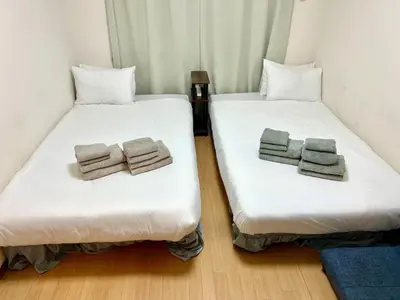 two beds in a room with towels on them at Fuji Flats - Vacation STAY 35595v in Tokyo