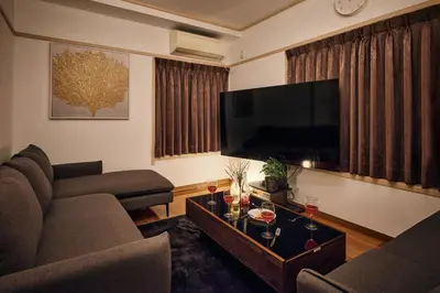 a living room with a couch and a tv at \u3068\u307e\u308a\u30fc\u3068Stay \u5e61\u30f6\u8c37 \u6e0b\u8c37\u533a Tomareat Stay Hatagaya Shibuya City in Tokyo