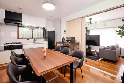 a kitchen and living room with a wooden table and chairs at \u3068\u307e\u308a\u30fc\u3068Stay \u5e61\u30f6\u8c37 \u6e0b\u8c37\u533a Tomareat Stay Hatagaya Shibuya City in Tokyo