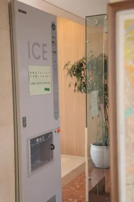 an ice machine in a room with a potted plant at KKR Hotel Nakameguro in Tokyo