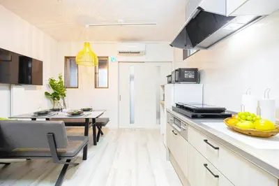 a kitchen with a counter and a table with a bowl of fruit at Disney nearby! 4bedroom family with airport access-Nobu in Tokyo