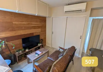 a living room with a couch and a tv at Westside Shinjuku-Gyoen 507 in Tokyo