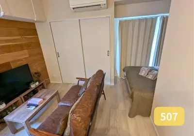 a living room with a couch and a television at Westside Shinjuku-Gyoen 507 in Tokyo
