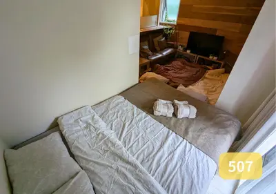 a bedroom with a bed with two towels on it at Westside Shinjuku-Gyoen 507 in Tokyo