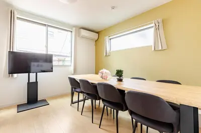 a conference room with a large wooden table and chairs at Jtr\u5927\u548c\u753a1\u4e01\u76ee\u6238\u5efa in Tokyo