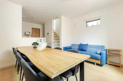 a dining room with a table and a blue couch at Jtr\u5927\u548c\u753a1\u4e01\u76ee\u6238\u5efa in Tokyo