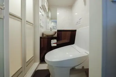a bathroom with a white toilet and a sink at monthly Ra Grande in Tokyo