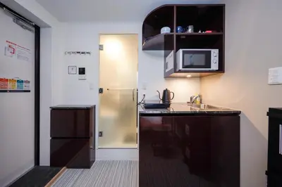 a small kitchen with a sink and a microwave at monthly Ra Grande in Tokyo