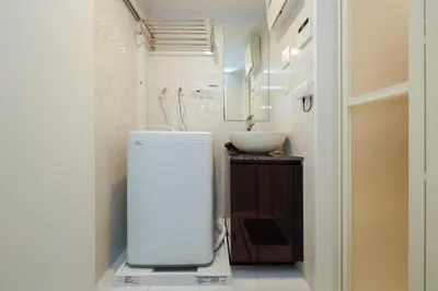 a small bathroom with a sink and a refrigerator at monthly Ra Grande in Tokyo