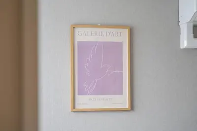 a framed picture of a bird hanging on a wall at monthly prime shinjuku in Tokyo