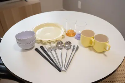 a white table with cups and utensils on it at monthly prime shinjuku in Tokyo