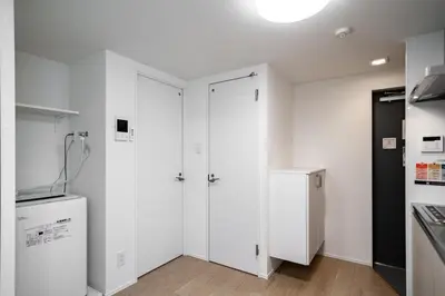 a kitchen with white cabinets and a refrigerator at monthly prime shinjuku in Tokyo