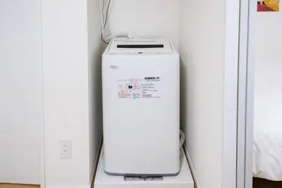 a washing machine sitting on a shelf in a room at monthly prime shinjuku in Tokyo