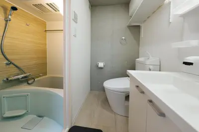 a bathroom with a toilet and a tub and a sink at monthly RECO WASEDA in Tokyo