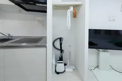 a kitchen with a black and white appliance at monthly RECO WASEDA in Tokyo
