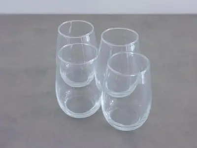 four empty wine glasses sitting on a table at LANG Hotel Kitaueno in Tokyo