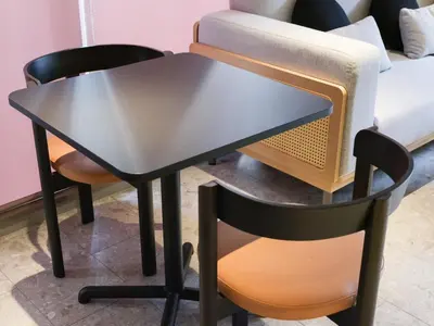 a black table with a chair and a couch at LANG Hotel Kitaueno in Tokyo