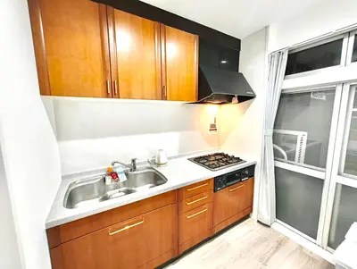 a small kitchen with a sink and a stove at Nippori mansion#Arakawa-ku in Tokyo