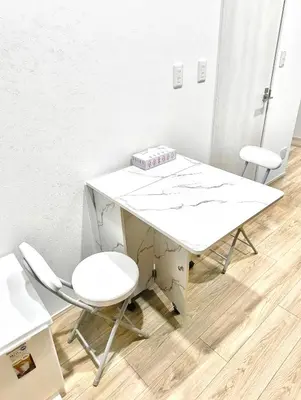 a white desk and two chairs in a room at Nippori mansion#Arakawa-ku in Tokyo