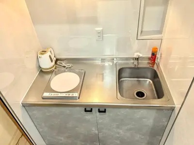 a small kitchen with a sink and a counter at Nippori mansion#Arakawa-ku in Tokyo