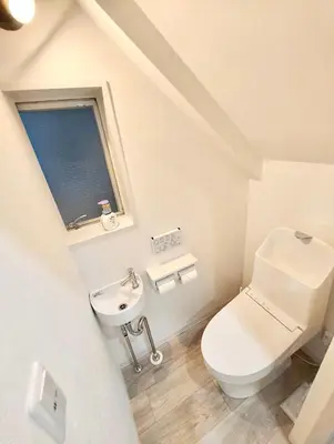 a white bathroom with a toilet and a sink at Nippori mansion#Arakawa-ku in Tokyo