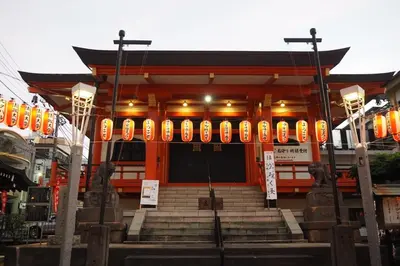 a building with orange and yellow signs on it at Etoile Kagurazaka-Queen Room near Shinjuku, Self Check-in in Tokyo