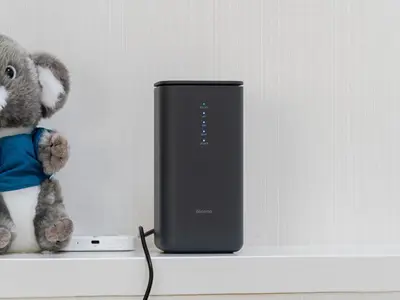 a teddy bear sitting on a shelf next to a computer at Shibuya Sta 10min walk Kingbed VR Switch Wi-Fi in Tokyo