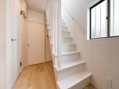 a white staircase in a home with a window at Shibuya Sta 10min walk Kingbed VR Switch Wi-Fi in Tokyo