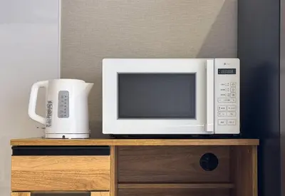 a microwave oven sitting on top of a wooden stand at GInza6-7F in Tokyo