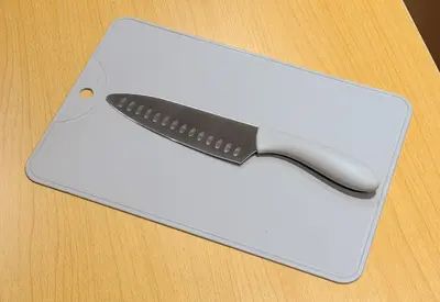 a knife sitting on top of a white cutting board at GInza6-7F in Tokyo
